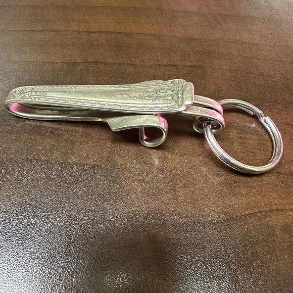 Silver fork bent into a key chain. It could also be worn as a necklace - Picture 1 of 3